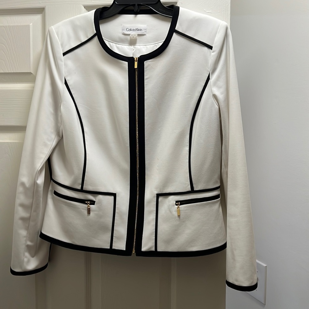 White Calvin Klein blazer with black trim.